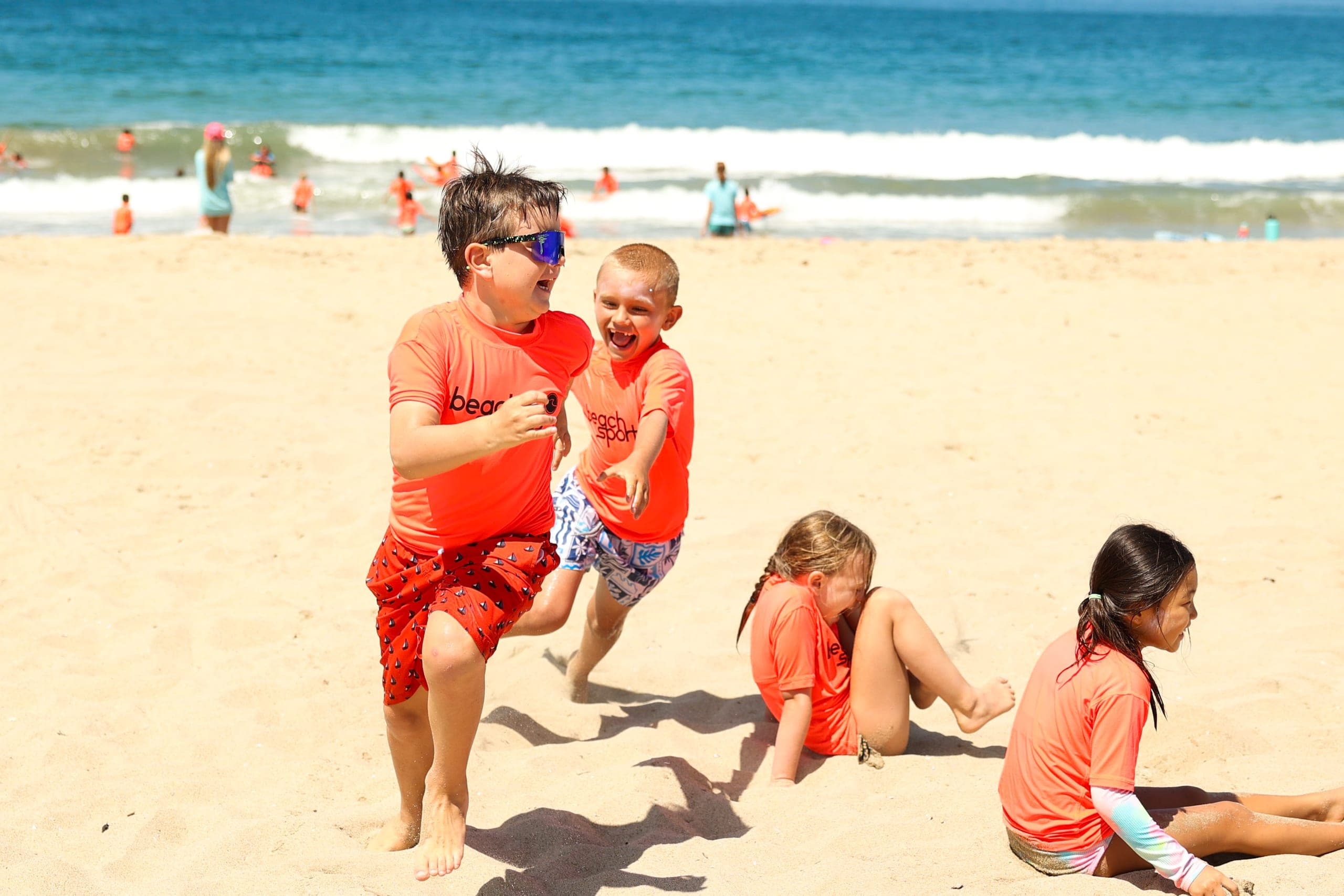 Young BeachSports campers discovering the beach with a coach