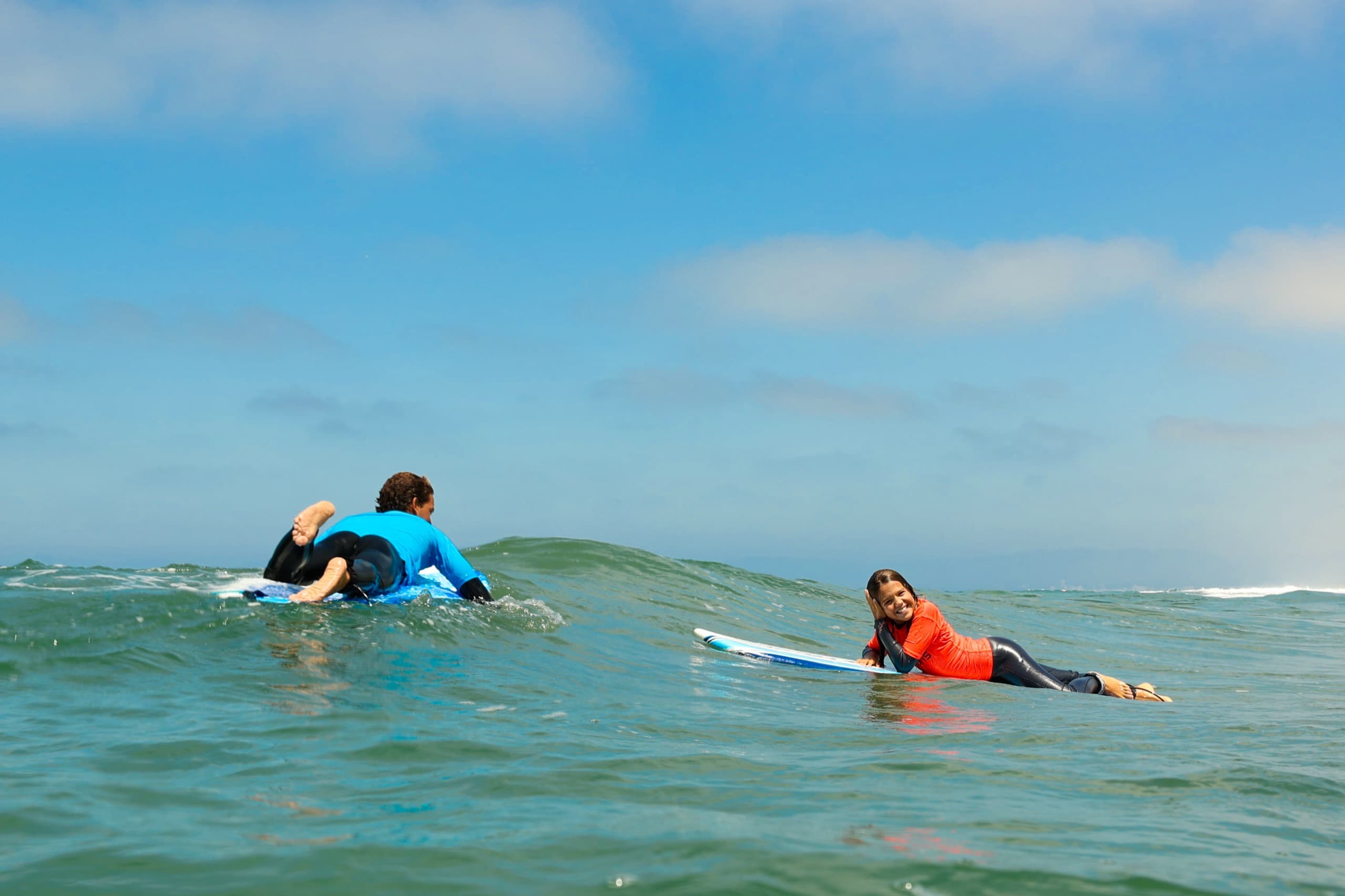 Campers paddling boards beyond the shore break