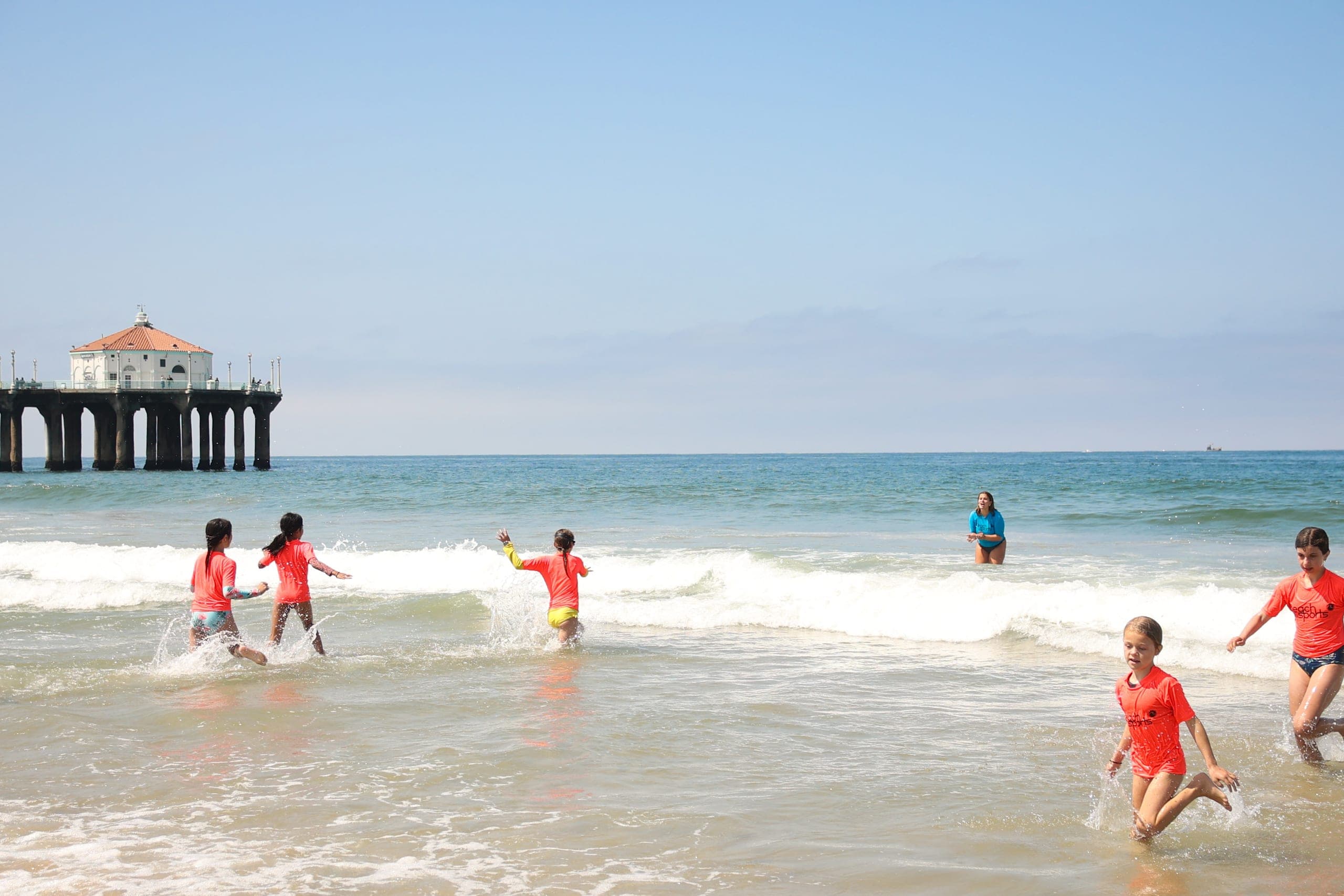 Ocean Program campers swimming out through the surf together