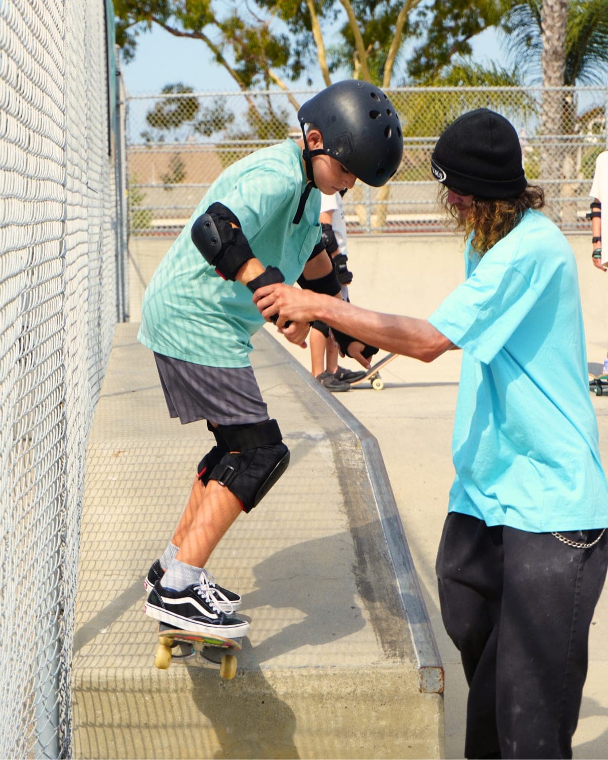 A coach-in-training helping campers