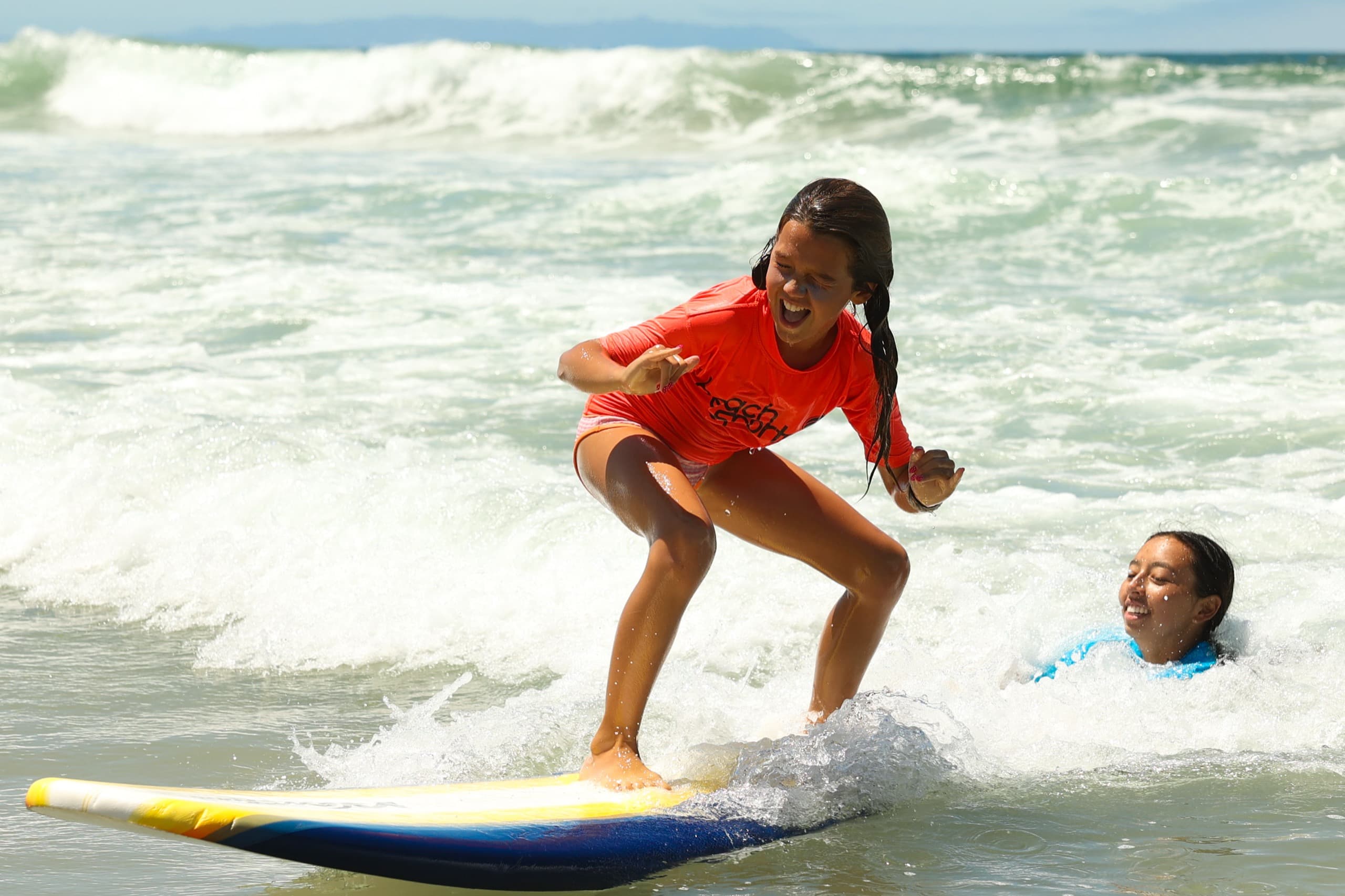 A camper riding a wave