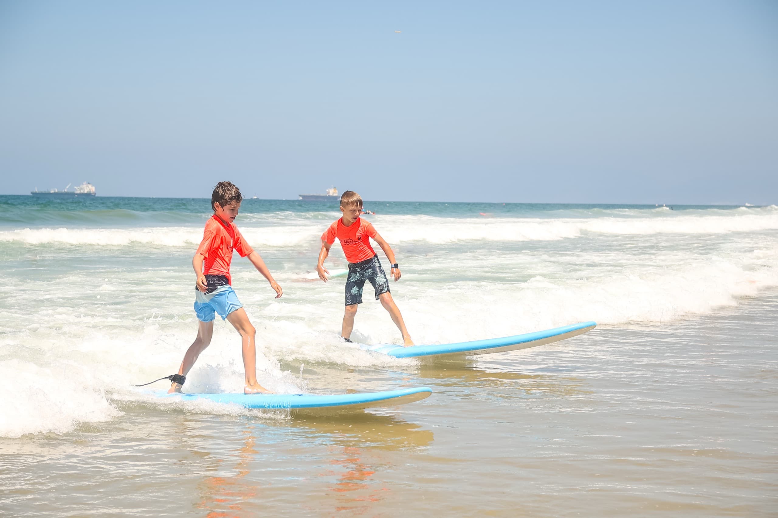 Campers surfing on a sunny South Bay morning