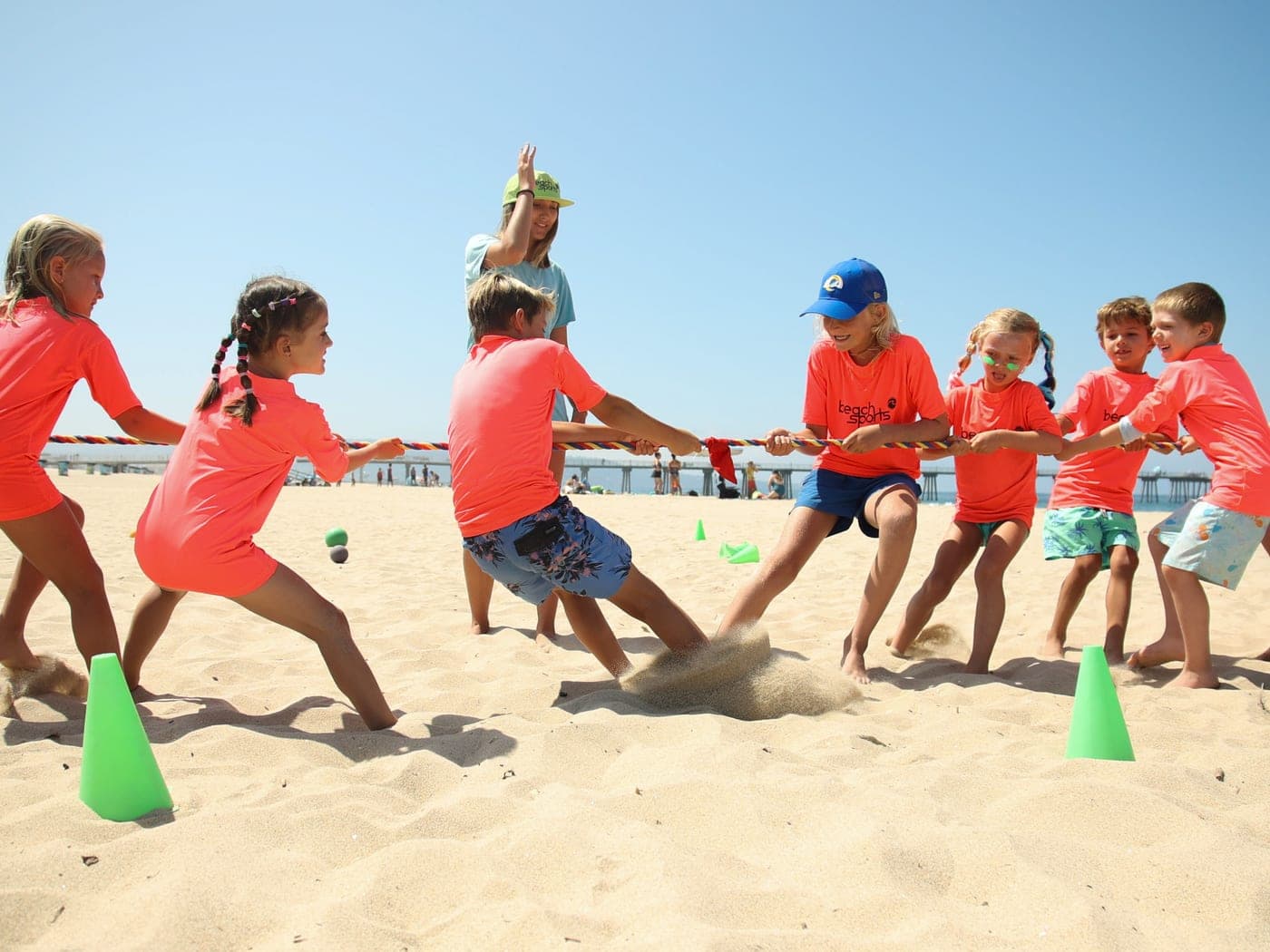 BeachSports campers and coaches playing a group beach game together