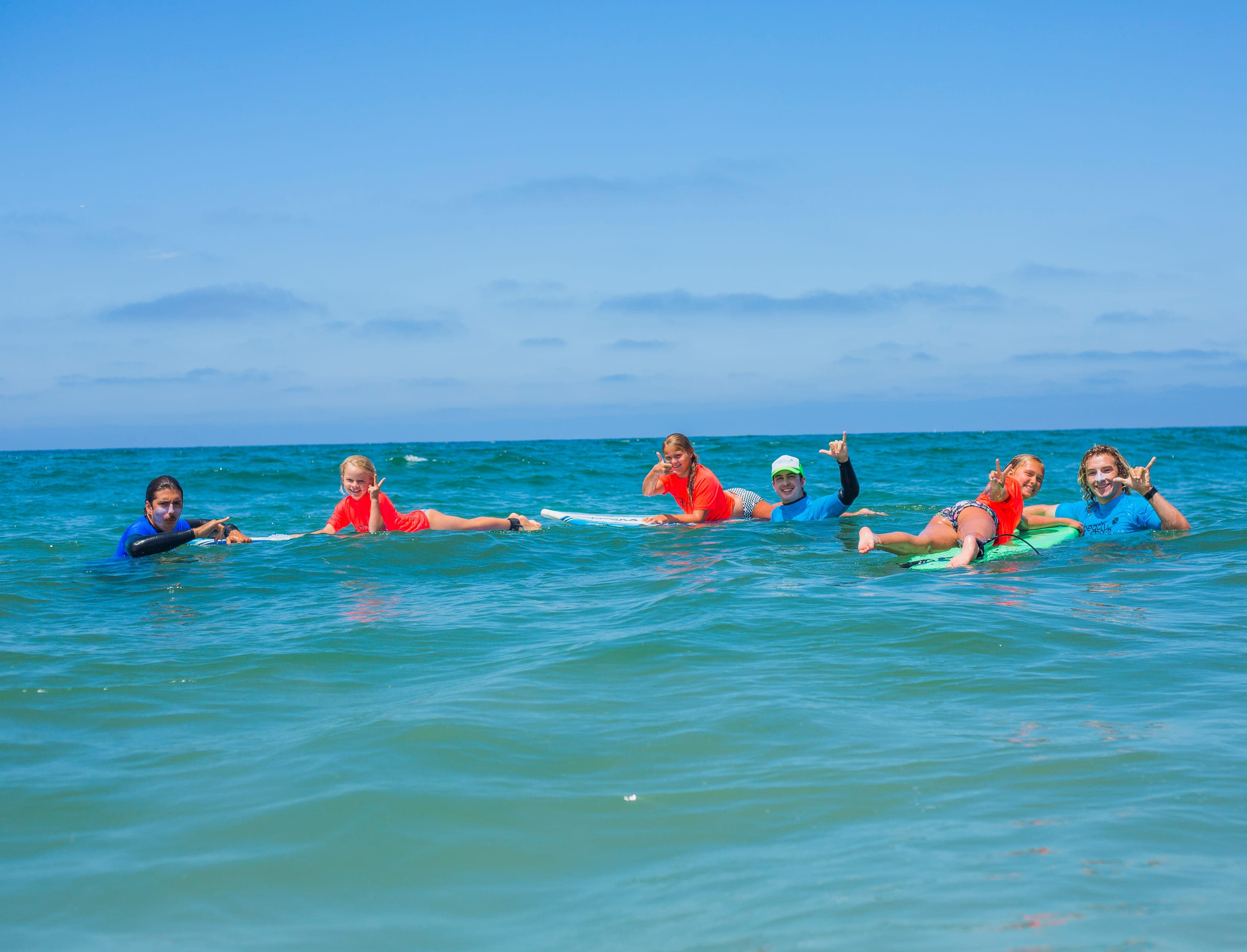 BeachSports surf coaches paired one-on-one with young campers in the ocean